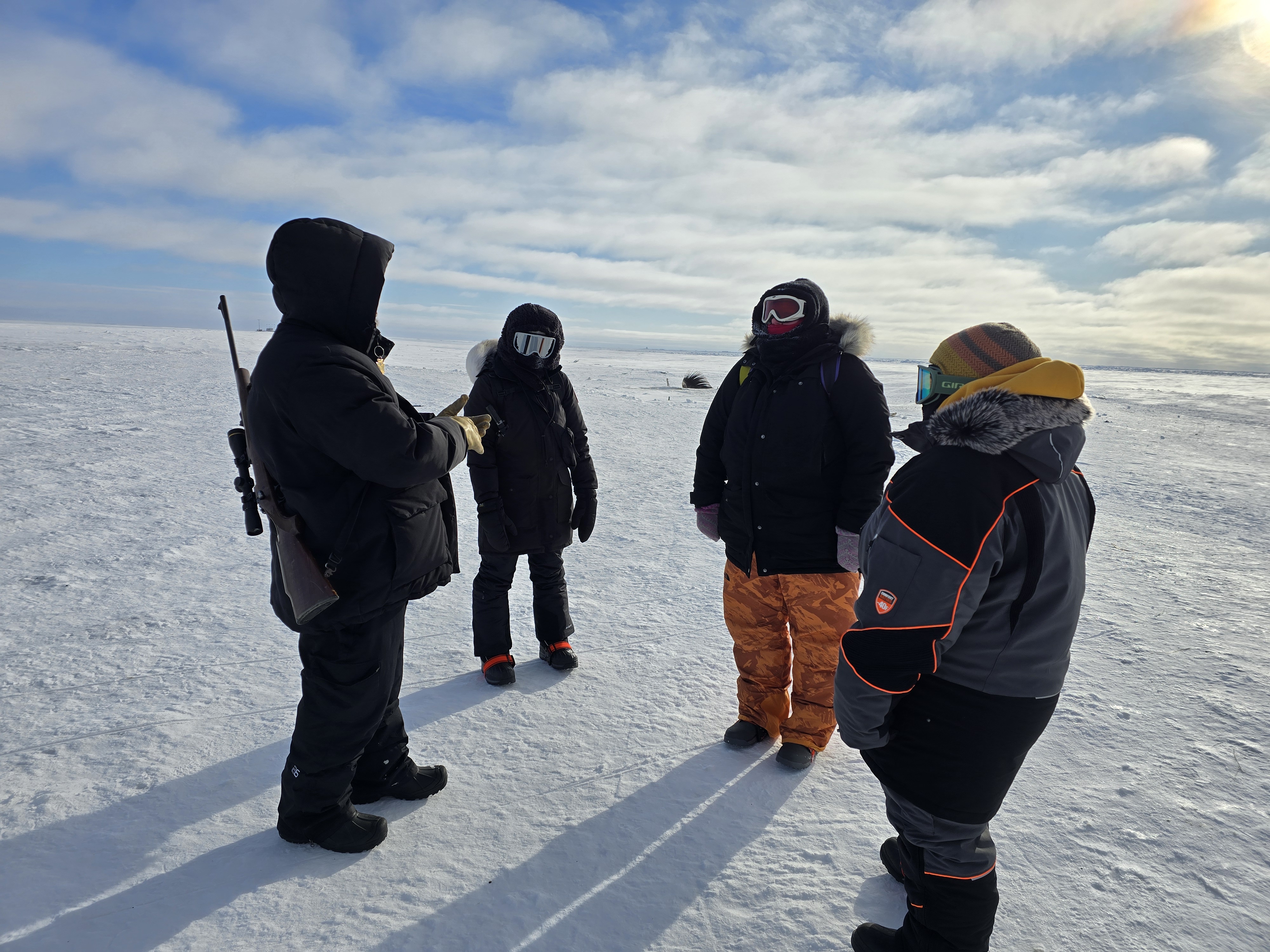 Guests being guided at Point Barrow — the northernmost point in the United States — on a Kiita Tours Arctic experience from Utqiaġvik, Alaska