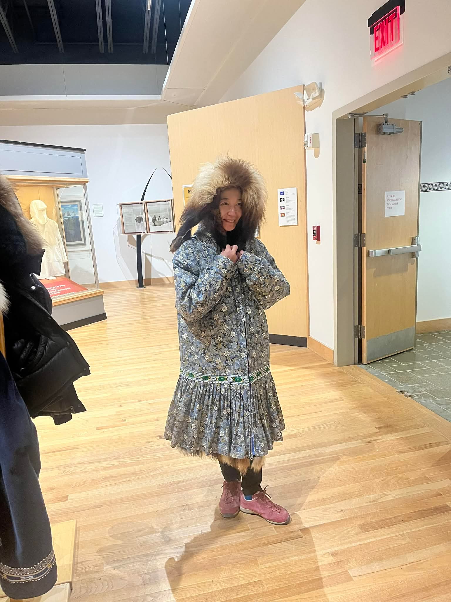 Guest wearing a traditional Iñupiat parka at the Iñupiat Heritage Center