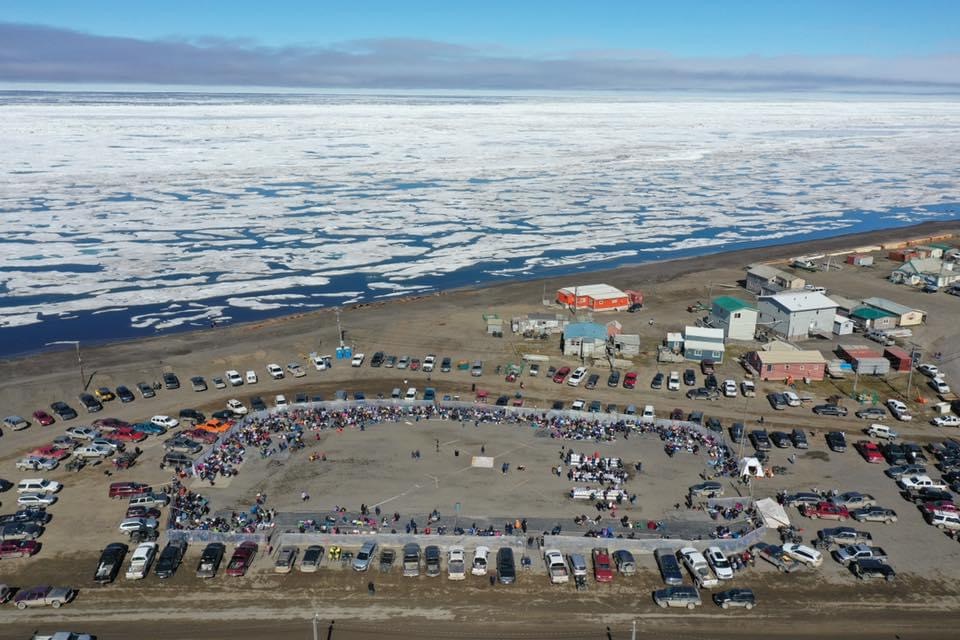 Aerial view of a community gathering along the Arctic coastline of Utqiaġvik